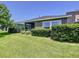Exterior view of the home highlighting the screened-in porch and well-manicured lawn at 6932 Old Benton Dr, Apollo Beach, FL 33572