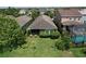 Aerial view of backyard with pool, lush landscaping, and screened patio at 6932 Old Benton Dr, Apollo Beach, FL 33572