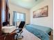 Functional room features a bed and an office setup, perfect for work or rest at 6932 Old Benton Dr, Apollo Beach, FL 33572