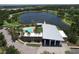 Aerial view of a modern clubhouse with pool and a beautiful lake at 6932 Old Benton Dr, Apollo Beach, FL 33572