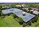 Aerial view of community tennis and pickleball courts surrounded by lush landscaping at 6932 Old Benton Dr, Apollo Beach, FL 33572