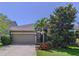Charming single-Gathering home featuring a landscaped front yard and covered entry at 6932 Old Benton Dr, Apollo Beach, FL 33572