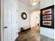 Inviting hallway with hardwood floors, decorative mirror, and arched doorway at 6932 Old Benton Dr, Apollo Beach, FL 33572