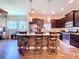 Modern kitchen features an island with bar seating, stainless steel appliances, and pendant lighting at 6932 Old Benton Dr, Apollo Beach, FL 33572