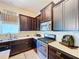 Stylish kitchen featuring stainless steel appliances, dark cabinetry and tile backsplash at 6932 Old Benton Dr, Apollo Beach, FL 33572