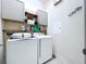 Functional laundry room with white washer, dryer, and convenient shelving at 6932 Old Benton Dr, Apollo Beach, FL 33572