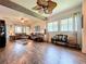 Inviting living room with hardwood floors, beamed ceilings, and neutral decor creating a cozy atmosphere at 6932 Old Benton Dr, Apollo Beach, FL 33572