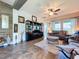 Open living room with hardwood floors, plush seating, and a media center at 6932 Old Benton Dr, Apollo Beach, FL 33572