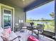 Inviting screened patio with comfortable furniture and scenic outdoor view of the lake at 6932 Old Benton Dr, Apollo Beach, FL 33572