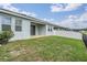 Home's backyard featuring sliding glass door, patio, and lake views at 8576 Broadstone Dr, Wesley Chapel, FL 33544