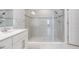 A modern bathroom showcases a sleek vanity and a spacious, tiled walk-in shower enclosed with glass doors at 8576 Broadstone Dr, Wesley Chapel, FL 33544