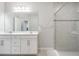 Modern bathroom featuring a double sink vanity with white cabinets and a glass-enclosed walk-in shower with gray tiling at 8576 Broadstone Dr, Wesley Chapel, FL 33544