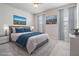 A virtually staged primary bedroom features a bed, artwork, and windows, creating a cozy and inviting atmosphere at 8576 Broadstone Dr, Wesley Chapel, FL 33544