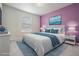 Staged primary bedroom with luxury bedding and modern decor at 8576 Broadstone Dr, Wesley Chapel, FL 33544
