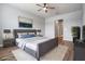 Bedroom with neutral paint, wood flooring, gray accent bed and decorative pillows at 8576 Broadstone Dr, Wesley Chapel, FL 33544