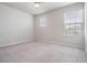 An empty bedroom with carpet and natural light at 8576 Broadstone Dr, Wesley Chapel, FL 33544