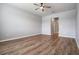 Bedroom featuring wood-style floors, neutral paint, and natural light at 8576 Broadstone Dr, Wesley Chapel, FL 33544