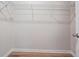 Walk-in closet with wire shelving and wood flooring at 8576 Broadstone Dr, Wesley Chapel, FL 33544