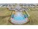 Aerial view of a beautiful community pool with lounge chairs and covered seating areas at 8576 Broadstone Dr, Wesley Chapel, FL 33544