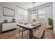Dining room with seating for six, buffet and modern lighting at 8576 Broadstone Dr, Wesley Chapel, FL 33544