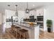 Staged kitchen featuring white cabinets, granite countertops, stainless steel appliances, and breakfast bar at 8576 Broadstone Dr, Wesley Chapel, FL 33544