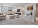 This virtually staged living room showcases a comfortable seating area, artwork, and a cozy, inviting ambiance at 8576 Broadstone Dr, Wesley Chapel, FL 33544