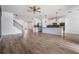 Open living space with modern finishes, wood floors, white kitchen, and staircase at 8576 Broadstone Dr, Wesley Chapel, FL 33544