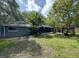 Beautiful backyard with a screened-in patio and tropical foliage creating a private outdoor oasis at 939 Woodland Dr, Palm Harbor, FL 34683
