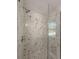 The bathroom features a glass enclosed shower with white marble and pebble tile base at 939 Woodland Dr, Palm Harbor, FL 34683