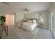 This spacious bedroom features a ceiling fan, sliding glass door, and a large rug at 939 Woodland Dr, Palm Harbor, FL 34683
