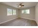 Bright bedroom with new wood-look flooring and large windows offering backyard views at 939 Woodland Dr, Palm Harbor, FL 34683