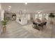 Spacious open-concept kitchen with a large island, stainless steel hood, and light gray flooring at 939 Woodland Dr, Palm Harbor, FL 34683