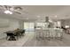 Open concept kitchen with a center island, bar stool seating, and a view of the backyard pool at 939 Woodland Dr, Palm Harbor, FL 34683