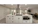 Bright kitchen with a white center island, stainless steel appliances, and sleek black hardware at 939 Woodland Dr, Palm Harbor, FL 34683
