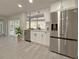 Modern kitchen featuring stainless steel appliances, light cabinets, and a view of the backyard at 939 Woodland Dr, Palm Harbor, FL 34683
