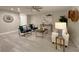 Contemporary living room featuring sleek furniture, decor, and light wood-look flooring at 939 Woodland Dr, Palm Harbor, FL 34683