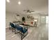 Inviting living room with neutral paint, modern furniture, ceiling fan, and light gray flooring at 939 Woodland Dr, Palm Harbor, FL 34683
