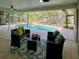 Screened pool area with an in-ground pool surrounded by patio with outdoor seating at 939 Woodland Dr, Palm Harbor, FL 34683