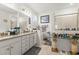 Bright bathroom featuring a granite countertop with double sinks, drawers, and a large mirror at 944 Old Windsor Way, Spring Hill, FL 34609