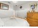 Cozy bedroom with white bedding, a wooden dresser, and a chandelier for a relaxing ambiance at 944 Old Windsor Way, Spring Hill, FL 34609