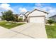 Charming home with a two-car garage, manicured lawn, and tastefully landscaped front yard at 944 Old Windsor Way, Spring Hill, FL 34609