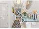 Elegant hallway with a zebra-striped rug and glass-top console table featuring decorative vases and a modern chandelier at 944 Old Windsor Way, Spring Hill, FL 34609
