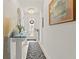 Inviting hallway with a zebra-striped rug, glass-top console table, and elegant decor leading to the front door at 944 Old Windsor Way, Spring Hill, FL 34609