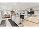 Open concept kitchen flowing into the living and dining areas, featuring a center island and stainless steel appliances at 944 Old Windsor Way, Spring Hill, FL 34609