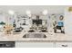 Spacious kitchen island with granite countertop, stainless steel sink, and modern lighting fixtures at 944 Old Windsor Way, Spring Hill, FL 34609