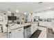 Open kitchen with island and dining area flowing into a bright living space with sofa and stylish decor at 944 Old Windsor Way, Spring Hill, FL 34609