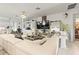 Elegant living room featuring a large white sofa, zebra-print accents, a mirrored coffee table, and built-in shelving at 944 Old Windsor Way, Spring Hill, FL 34609