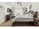 Main bedroom featuring a ceiling fan, window, decorative wall decor, and furniture at 944 Old Windsor Way, Spring Hill, FL 34609