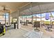 Screened-in patio with ceiling fan, roll down shades, and multiple seating areas at 944 Old Windsor Way, Spring Hill, FL 34609