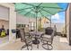 Covered outdoor seating area on a screened-in patio with garden views at 944 Old Windsor Way, Spring Hill, FL 34609